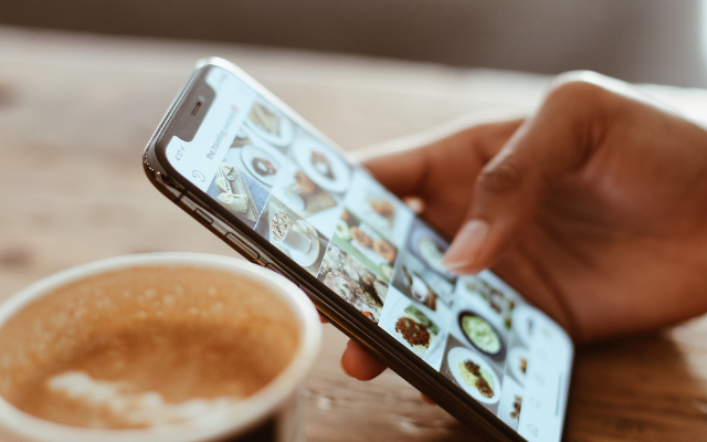 Hand checking SNS at cafe