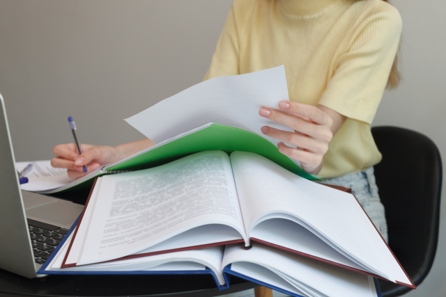 woman writing graduation thesis